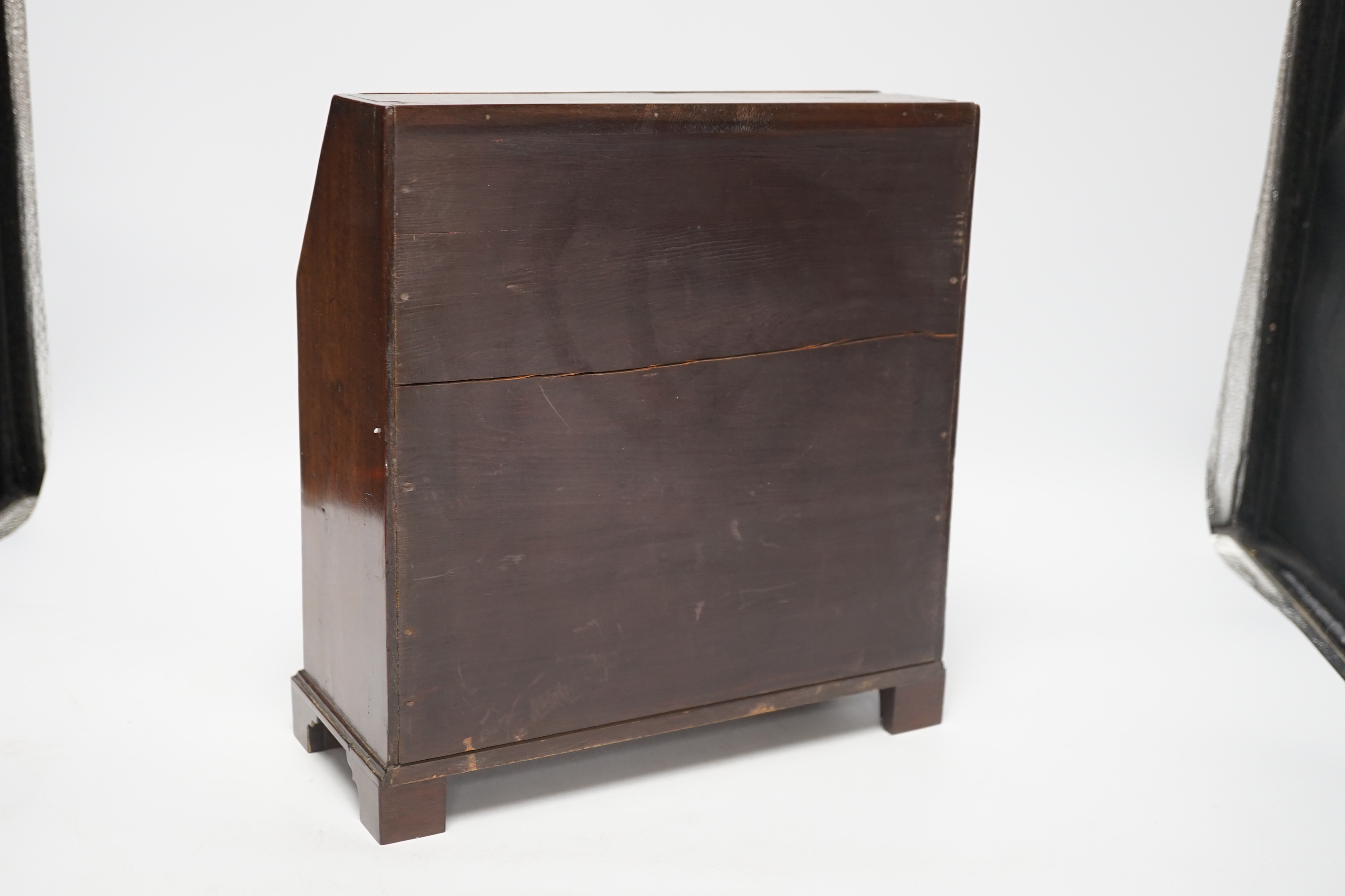 A George II miniature mahogany bureau with fitted interior and three drawers, 27cm high